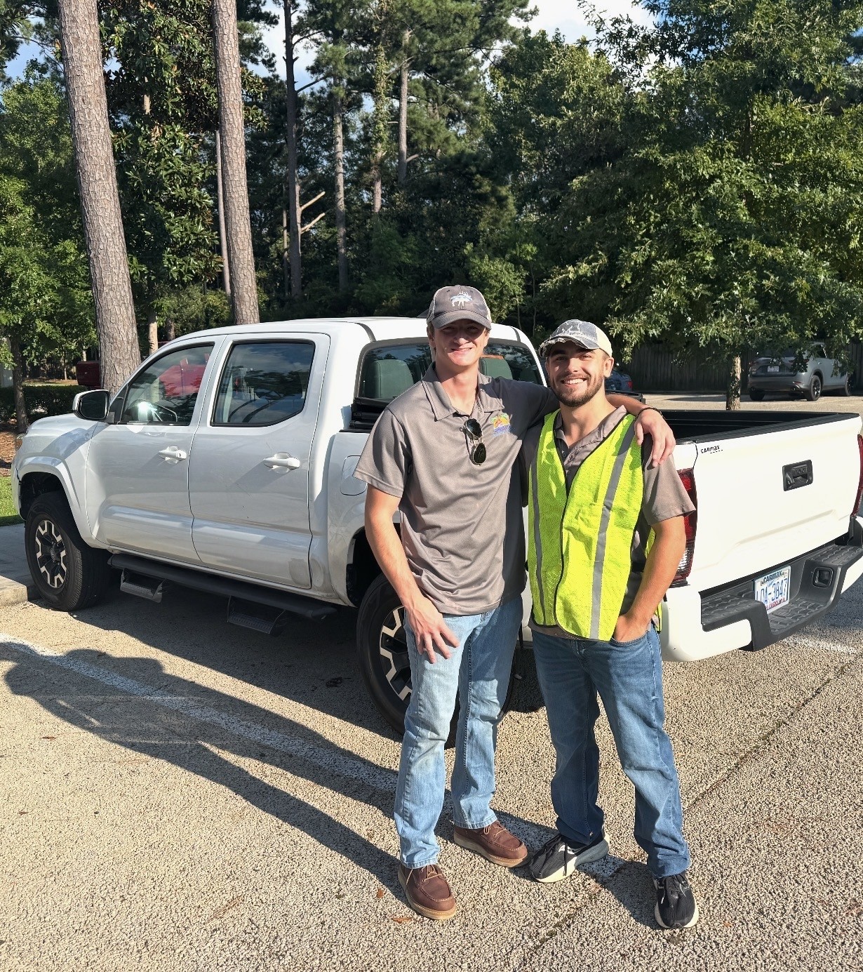 The C & B Junk Removal team standing beside their truck